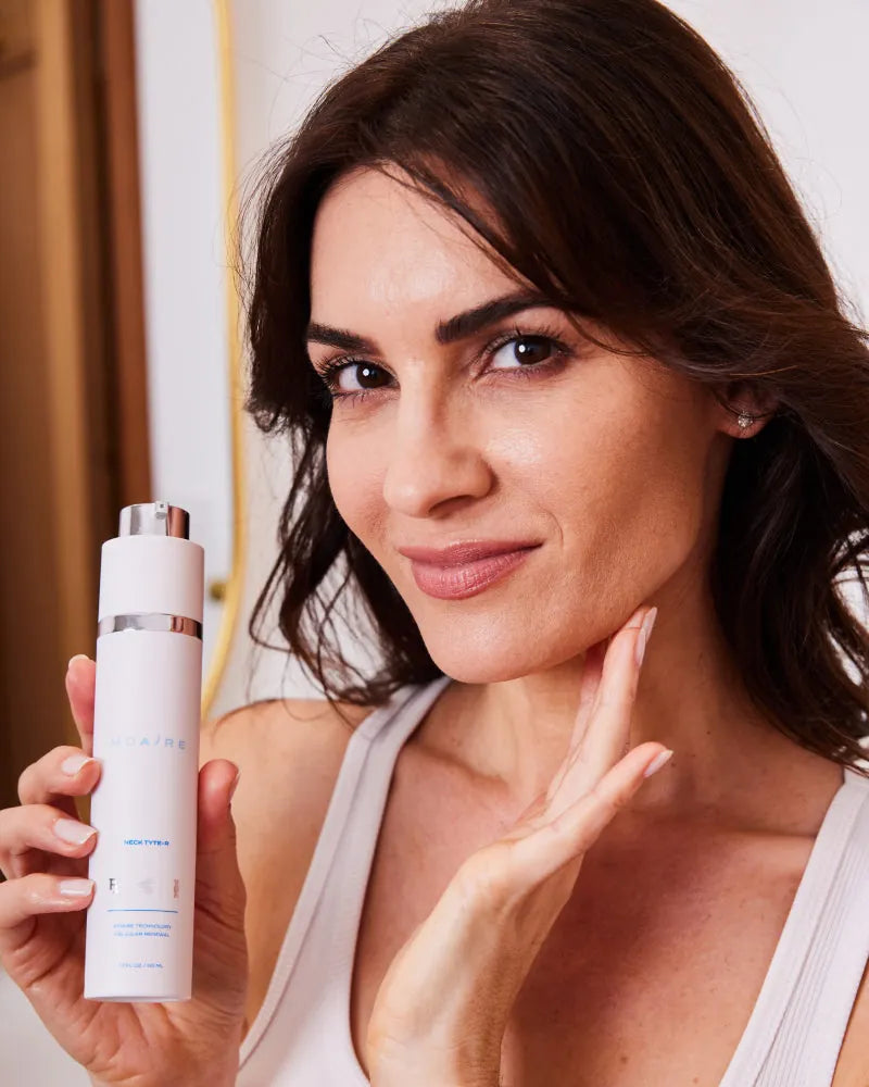 Complete System Bundle featuring woman showcasing sleek white serum bo