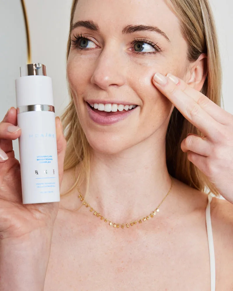 Complete System Bundle featuring woman applying peptide-rich serum on 